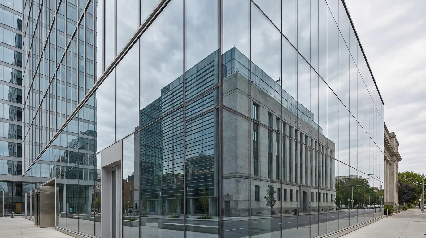 Bank of Canada building exterior reflected in modern glass architecture under overcast sky